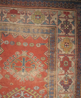Kazak Rug, Old, Colorful with a Kufic border. Several blues and greens, two natural oranges, great aubergine highlights. In "as found" condition. browns are corroded and there are several rips or rather  ...