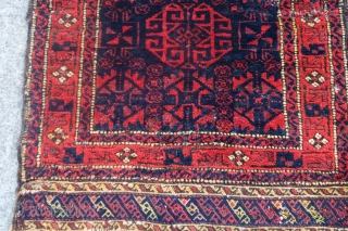 Baluch balisht with radiant reds and glossy wool. Silk highlights in the flatwoven ends. Cochineal used as abrash in the central geometric ornament.          