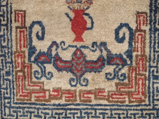 Unusual small Chinese rug with auspicious bats and flower pots. Uncommon use of madder red and un-dyed brown wool pile. cotton foundation. Perhaps Ningxia but seems a bit aberrant.  Perhaps Gansu  ...