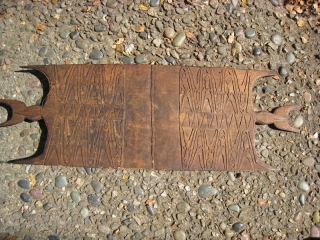 West Papua (Irian Jaya) shield.  10 x 30 inches.  Stylized human figure design.  One point of "horns" on each end chipped.  Back somewhat darker than front.  Purchased  ...