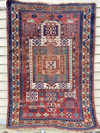 Kazak prayer rug - about 3’’6” x 4’10”. Great format, color and weave but not without wear, tear and crude repair (inc duct tape).         