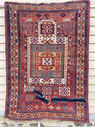 Kazak prayer rug - about 3’’6” x 4’10”. Great format, color and weave but not without wear, tear and crude repair (inc duct tape).         