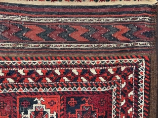 Baluch rug with overall design of Turkmen 'ayna' guls in full pile with complete plain-weave skirts - 2.44m x 1.17m (8' 0" x 3' 10").        