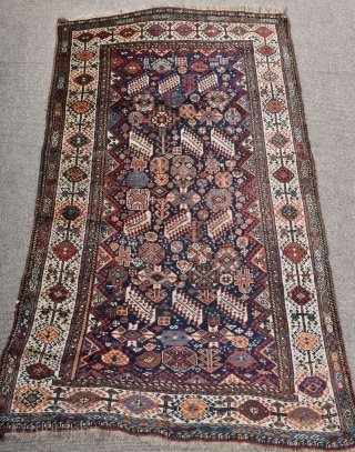 An antique Shekarlu Qasgai rug of unusual small size. Typical design, with a riot of colourful filler elements framed by sunburst borders. A good tribal rug this, with fine silky wool and  ...