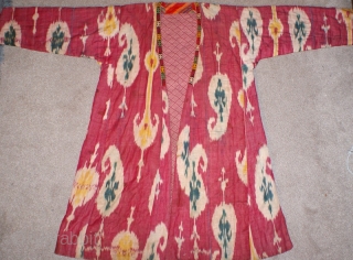 19th century Uzbek Adras Silk wrap/ cotton weft Ikat Chapan ( Coat). Excellent natural colours and bodom gul (almond) design. Beautiful linen, spectacular cross stitches on neck part edges. Reasonable price.   ...