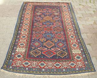 Kuba rug, 19th century.  Stunning saturated colors.  This Kuba rug is brimming with a variety of palmettes and medallions. Striking kufic border. Excellent condition. 128 x 213 cm.  Contact  ...