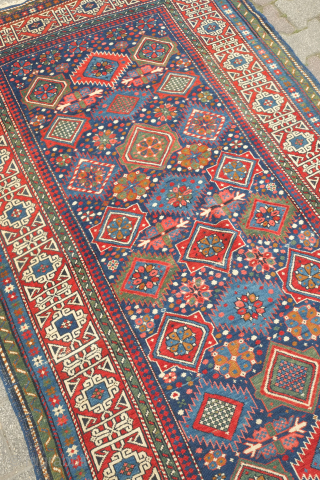 Kuba rug, 19th century.  Stunning saturated colors.  This Kuba rug is brimming with a variety of palmettes and medallions. Striking kufic border. Excellent condition. 128 x 213 cm.  Contact  ...