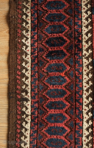 Khorassan Baluch rug, 4th quarter of the 19th century.  Saturated blues and rich brooding ember red.  Kilim ends in tact.  Linked hexagon border with "S" figures in the center  ...