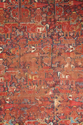 Khamseh rug, 3rd to 4th quarter of the 19th century.  A wonderful array of mounted tribesmen in the field amidst unique half abstract winged medallions.  The field is filled with  ...