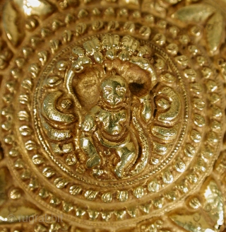 Hair Ornament
22k gold hair ornament, jadaibillai, from Bangalore, Karnataka. Repousse gold depicting Lord Krishna dancing on a 5 headed Naga. 19th c
Size: 2 5/8 inches diameter
 79.8 grams (repousse gold w/resin fill) 