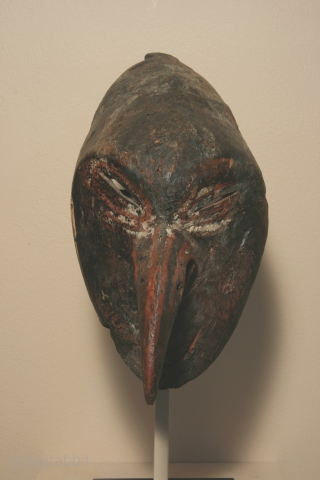 New Guinea coastal Sepic River "mosquito" style mask, wood and pigment,15 inches high, early 20th century. restoration to the top 5 inches of the mask. Provenance: Kevin Conru, Brussels. An early, finely  ...