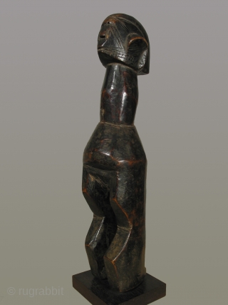 Africa, Mumuye wood figure, Nigeria, Benue River Valler Region, height 18 inches, circa 1900-1950, fine dark patina. Provenance:Gallery Argile, Paris
Facial features of eyes, nose, and mouth are flattened onto the form of  ...