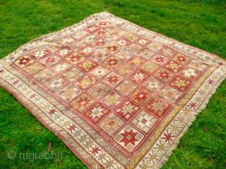 Beautiful mid 19th century Turkish rug. Condition, wear and small holes, but has been carefully repaired and backed, to make it a lovely, usable almost square rug. Size: 7' x 6'.9"  