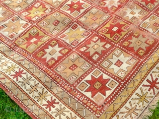 Beautiful mid 19th century Turkish rug. Condition, wear and small holes, but has been carefully repaired and backed, to make it a lovely, usable almost square rug. Size: 7' x 6'.9"  