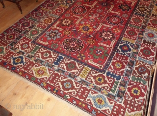 Coming soon ... Rather beautiful, with a bright festive red ground, this Shriven/Kuba small carpet is unusual for it's size; it has an attractive field of stylised floral medallions, enclosed within a  ...