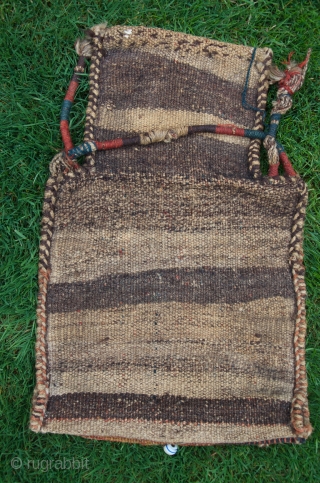 
Primeval antique Luri (?) namakdan. 1 ft. 10 in. x 1 ft. 2 in. Wool. Earthy natural colors. Decorated with glass and stone beads. Very rare. unique in my experience. Nearly perfect  ...