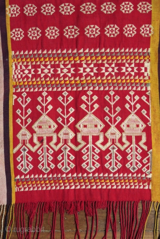 Borneo ceremonial carry-cloth (pua belantan)

Malaysia, Sarawak, Saribas region, 1950 or earlier

Cotton, silk, supplementary weft wrapping (sungkit)

A long solid red centrefield decorated at the ends in detailed silk sungkit, depicting two rows of  ...