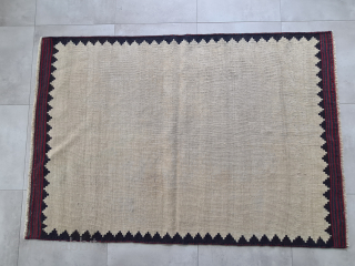 Persian Bakhtiary or Luri sofreh kilim with minimalistic nomadic pattern and naturel dyes. Two small not visible repairs in the  bright area. The edges are bordered

158x108cm 

Probably wovrn in the first  ...