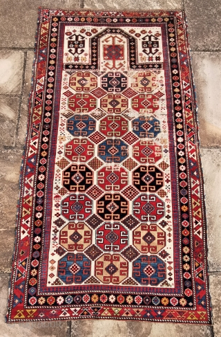 Shirvan prayer rug, about 1870, fairly rare design.
67in by 38in
This piece needs some t.l.c. missing outer guard border, and losses to pile           