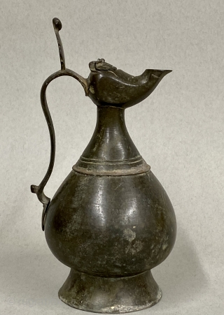 Seljuk Bronze Ewer, ca. 12th Century CE;

Diameter:  4 3/8” // 11.1 cm

Height - including crest:  9 5/8” // 24.4 cm

Diameter Base: 3 5/8” // 9.2 cm

Antique, gracefully pear-shaped ancient bronze  ...