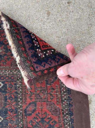 Antique Baluch rug with unusually good purple. 2'9" x 4'11". Selvedge missing on one side but backed by fabric.              