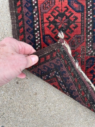 Antique Baluch rug with unusually good purple. 2'9" x 4'11". Selvedge missing on one side but backed by fabric.              