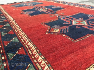 Antique Kazak rug. Beautiful open field with great greens and light blues. Good medium pile throughout. Dated. One old repair which is barely visible from the front.

Cheers.      