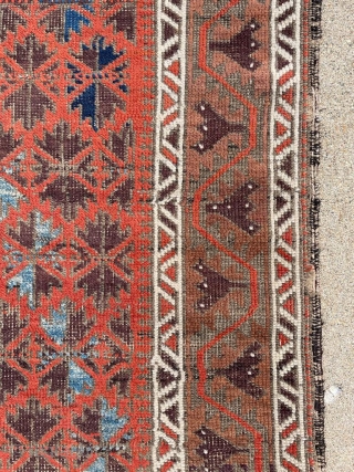 Antique symmetrically knotted Baluch rug with 11 colors and a striking light blue. The bottom edge wasn't cut, the weaver decided to shorten the two outer borders. No holes. 2'8" x 5'0"  ...