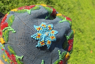 Exquisite micro beading to this purse made over 100 years ago, probably in France.Tiny beads, arranged to depict a wonderful assortment of flowers: roses, pansies, marigolds and Morning Glory in a broad  ...