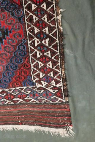 Mushwani Belouch/Baluch,  circa 1900,  2'10"x5'6",  wild and beautiful, with vivid red,  blue,  aubergine and white;  symmetrically knotted; kilim ends are complete except for small rough spot  ...