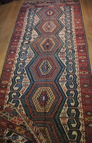 Antique Anatolian kilim, possibly from Aksaray region.
Size: 3,96 x 1,59  Age: Around 1900  
Materials: Wool in warp and wefts, except for all white areas which are in cotton
Technique: Splits covered  ...