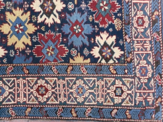 A Splendid blue ground star and rosette Caucaian Kuba runner, wonderful colours, well drawn field and green kufic border, original macrame ends, minor moth damage otherwise full pile, all original no repairs,  ...