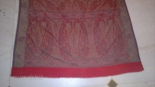 A 19TH CENTUARY WOVEN KASHMIR LONG SHAWL FROM INDIA. ITS A BEAUTIFUL SHAWL WITH DEEP RED CENTER. THE BEAUTIFUL BOTEH DESIGNS ON EITHER SIDES ARE VERY ELEGENT WITH LEAVES AND STEM RIBBONS  ...