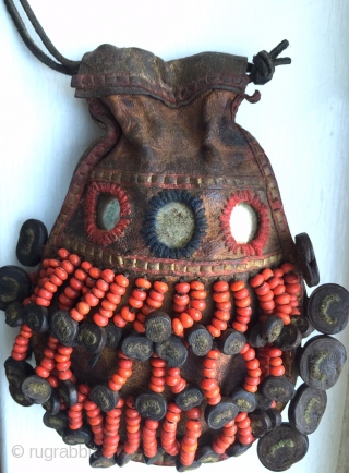 A very rare antique Beaded leather bag from Tibet or Ladakh India. Dating to the 19th century, such bags were part of the Buddhist traditions of the Hamaliyan people. The blood red  ...