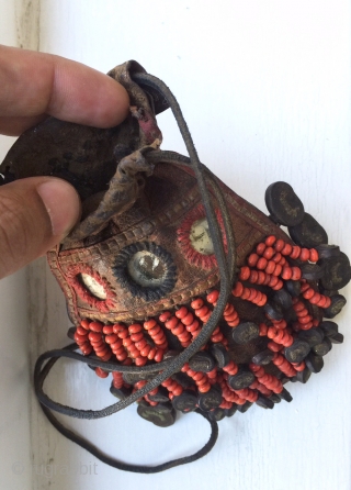 A very rare antique Beaded leather bag from Tibet or Ladakh India. Dating to the 19th century, such bags were part of the Buddhist traditions of the Hamaliyan people. The blood red  ...