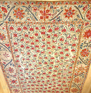 A stunning mid-19th century Antique Uzbek Bukhara Suzani, showcasing exceptionally fine silk embroidery on a linen Karbos ground. This large-scale masterpiece features chain-stitched and basma/flat stitch techniques. The vibrant field design displays  ...