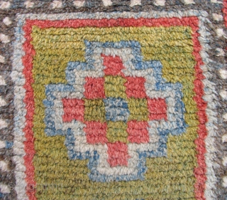 Tibetan three medallion rug. Luminous and lush with a delicate subtle, palette - the rug is old. a so-called Wangden type  with the warp predominant back. The knots were tied over  ...