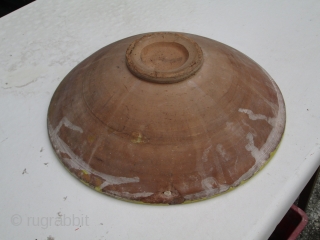 Spanish or Italian 19th.century red earthenware ceramic shallow bowl, glazed upper surface with quartered clover-leaf pattern in yellow, green and brown, has a very resonant ring when tapped suggesting fired at a  ...