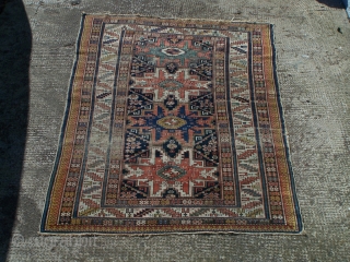 Shirvan rug, with column of four 'Lesghi' stars enclosed by ivory leaf-and-calyx border, cotton wefts, wool warps, very occasional synthetic orange (2 locations only approx -see detail image) in border, colours appear  ...