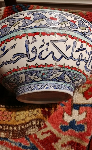 Old Turkish (Iznik?) bowl with calligraphic inscription.  Diameter 8.25 inches, 3.75 inches tall.  A crack and minor nick with old repair. Intact and stable,  Shows beautifully though fragile.   ...