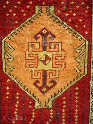 Anatolian yastik with amber hexagon spaceship medallion soaring over star-studded crimson field.  51 x 74 cm. -- Late 19th century.            