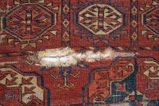 Early Tekke Main Carpet. with areas of wear, holes and a cut. 294cm x 206cm                  