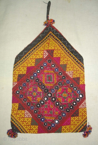 Dowry Bag(Bhujki),Mahar group,From Jaisalmer District of Rajasthan.India.Cotton embroidered with silk and cotton,mirrors,cotton tassels and string.H.30cm,W.20cm(DSC05959 New).                 