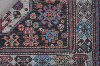 Kuba / Chadjli, 3' 11" x 9' 3", Late 19th C. This fine example of Kuba area workmanship has glowing colors with one end showing a weaker madder dye which has gone  ...