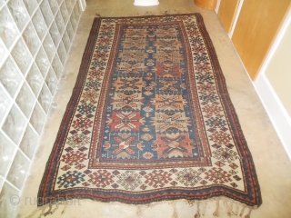 Antique Kazak Caucasian rug in good low pile condition. Still has some of its original tassel endings. 4'6" x 7'6."             