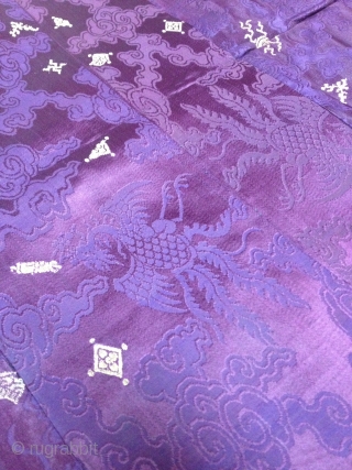 A male Tibetan Chuba (Male Robe), made from chinese damask brocade silk in deep purple color, all hand sewn. Brocade motifs comprise of dragons and phoenixes floating among the scroll of clouds,  ...