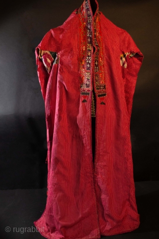  A rare Karakalpak Jegde head covering with ikat under arms, applique felt and embroidery lapel and other apliques at the slits on each side near embroidered hem. Polished cotton. Early 20th  ...