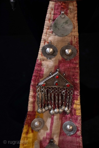 An antique Headdress with silver and carnelian stones and ikat flap in the back with silver ornamentation.  Yomud in Choresm Late 19th/ early 20th c.       