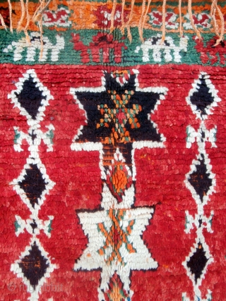 Long camel train depicted in this rare High Atlas rug from the Ait Douchen Berbers. The village uses an abandoned riyad as a center for weaving needs such as tools, looms, wools,  ...