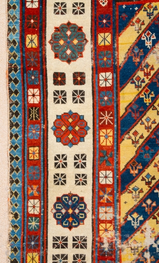 Middle of 19th Century South East Caucasian example, with an yellow and blue field and large rosettes in the white-ground main border, serves as a particularly good illustration of the design affinity  ...